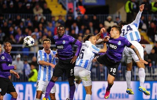 Malaga's Roque Santa Cruz (R) scores the second goal in Malaga on March 13, 2013